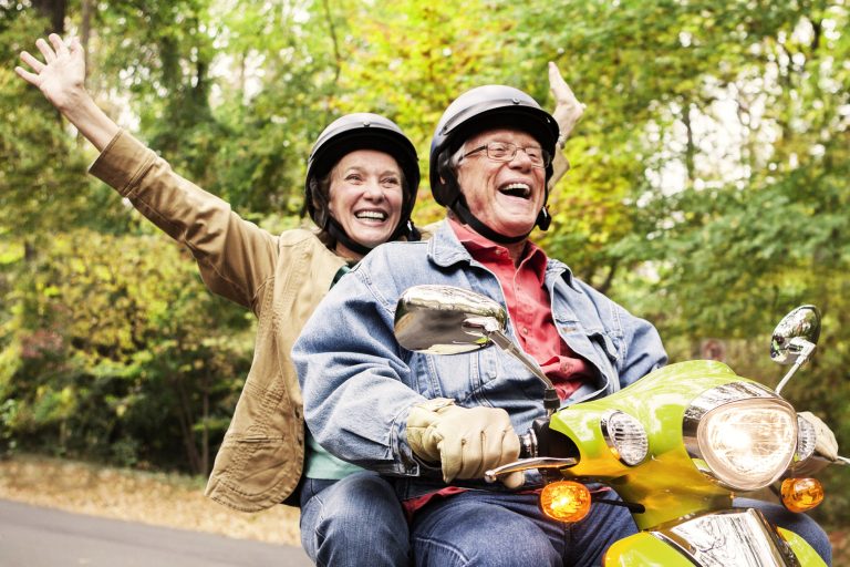 Couple on moped laughing